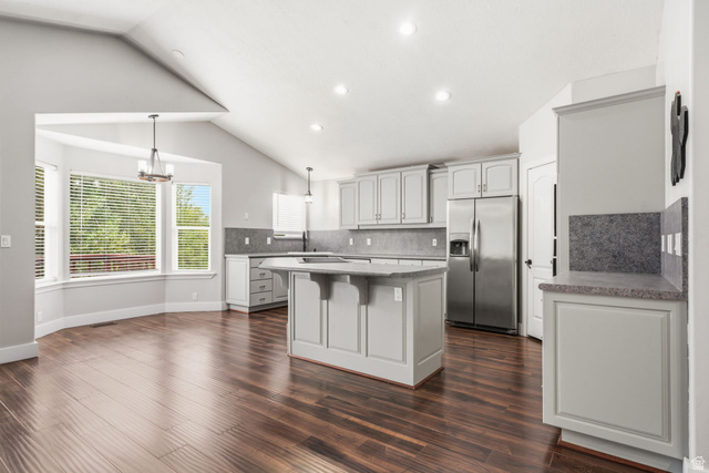 2154 Wasatch Boulevard Sandy, UT 84092 - Photo 9 of 32 Open-concept kitchen and dining area featuring wood-finish flooring, vaulted ceilings, and recessed lighting