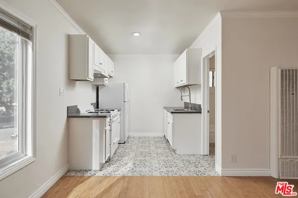 a kitchen with white cabinets and a sink