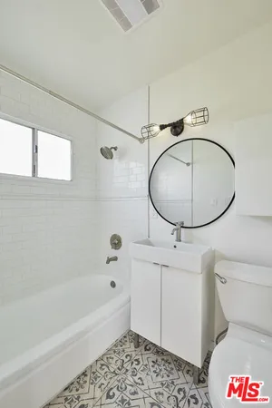 a bathroom with a sink a toilet and bathtub