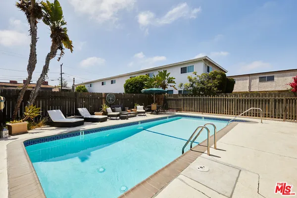 a view of swimming pool with outdoor seating and a patio