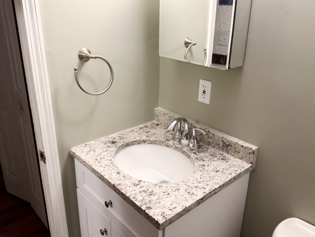 42 Swanson Court, Unit 14A Boxborough, MA 01719 - Photo 8 of 11 a bathroom with a granite countertop sink and a mirror