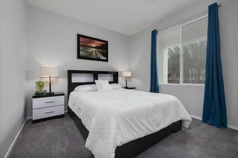 a bedroom with a bed and window