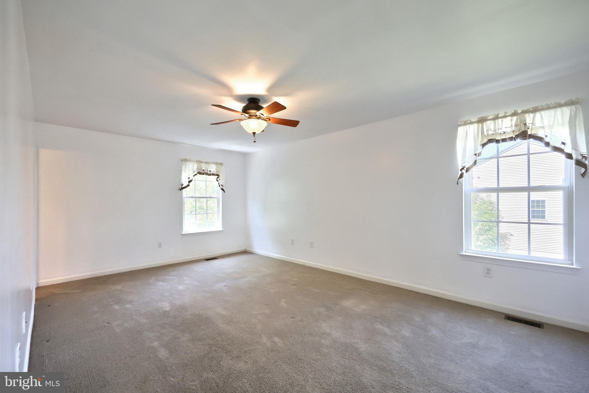 425 Lakeview Drive Spring Grove, PA 17362 - Photo 37 of 51 an empty room with windows and chandelier fan