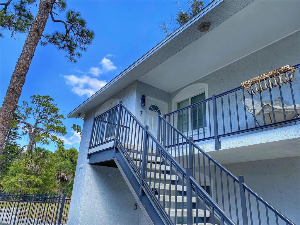 1090 Cocoanut Avenue, Unit 7 Sarasota, FL 34236 - Photo 1 of 7 a view of staircase with wooden floor and a potted plant