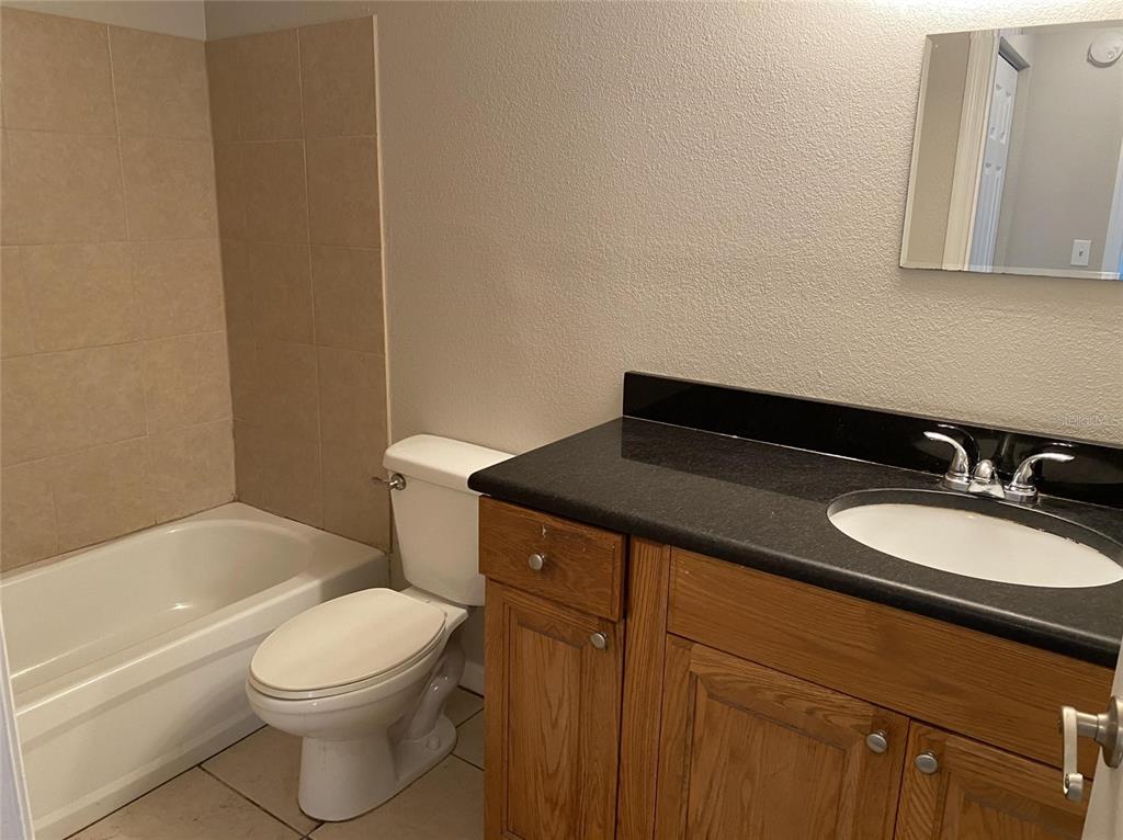 1090 Cocoanut Avenue, Unit 7 Sarasota, FL 34236 - Photo 7 of 7 a bathroom with a sink a toilet and bathtub
