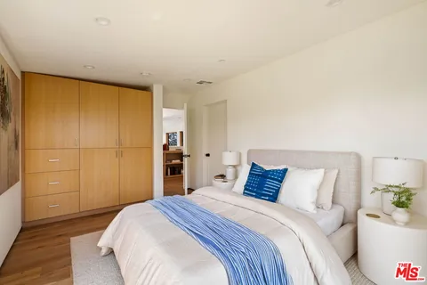 a bedroom with a bed and a cabinets