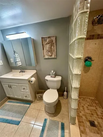 a bathroom with a double vanity sink toilet and shower