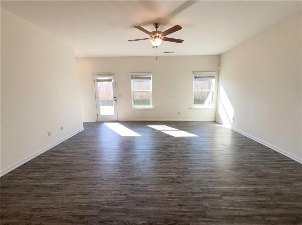 2682 North Broad Street Extension Northeast Rome, GA 30161 - Photo 10 of 23 an empty room with wooden floor and windows