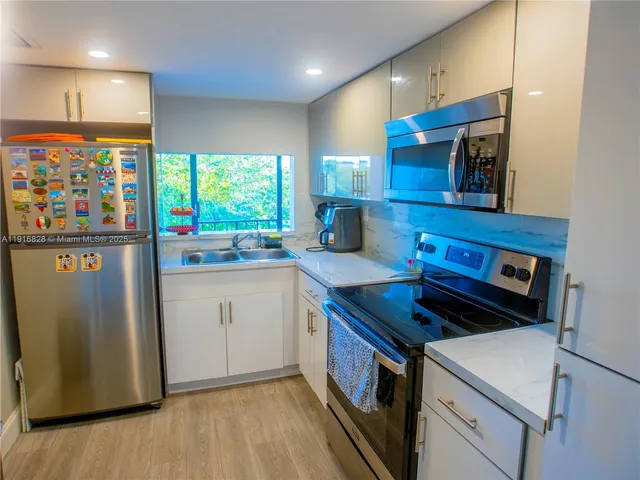 a kitchen that has a sink and a stove in it