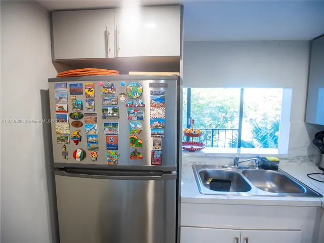 a sink sitting in a kitchen next to a window