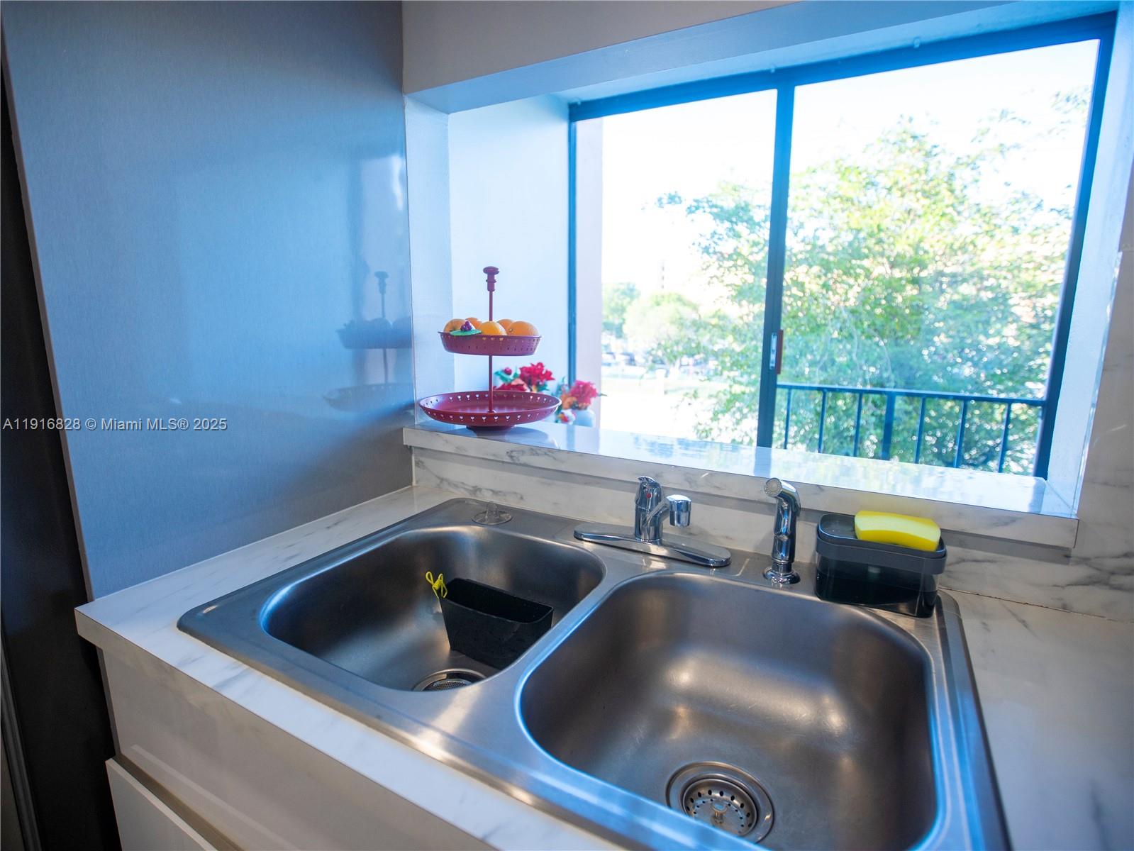 9400 West Flagler Street, Unit 313 Miami, FL 33174 - Photo 17 of 35 a kitchen with a sink and a window