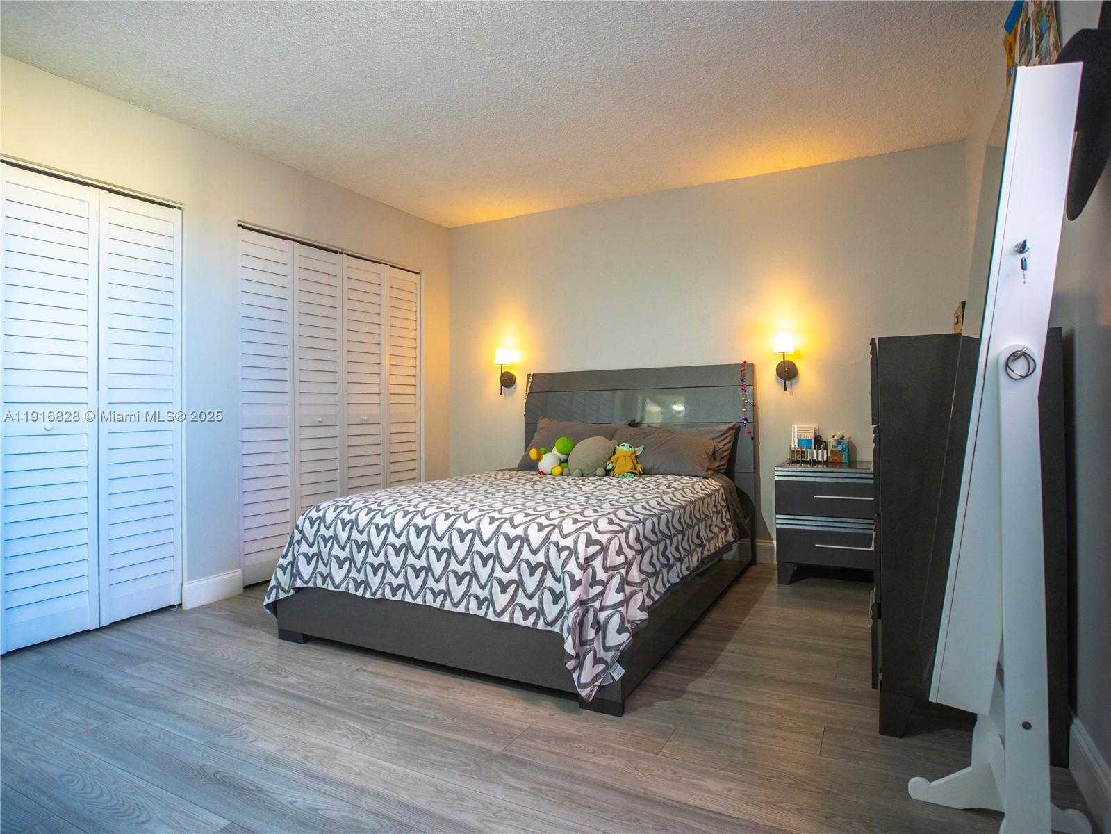 9400 West Flagler Street, Unit 313 Miami, FL 33174 - Photo 18 of 35 a bedroom with a bed a dresser and a window