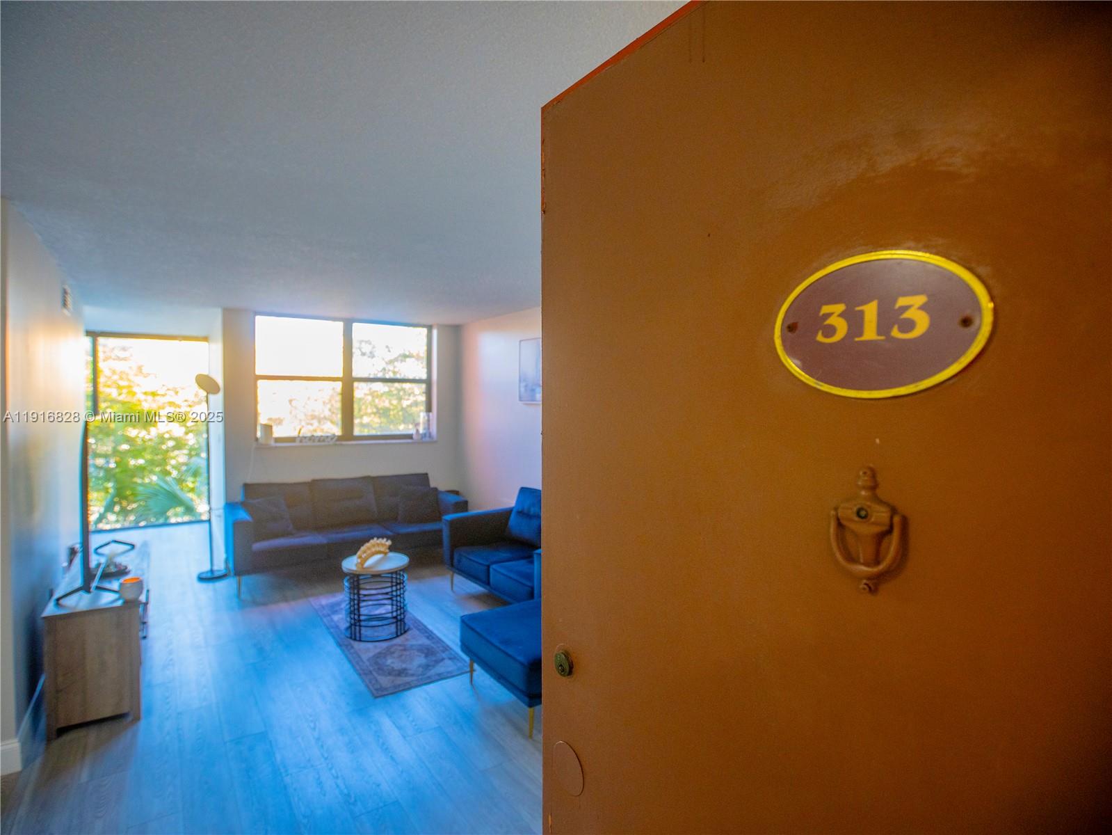 9400 West Flagler Street, Unit 313 Miami, FL 33174 - Photo 3 of 35 a view of a workspace with furniture and a window