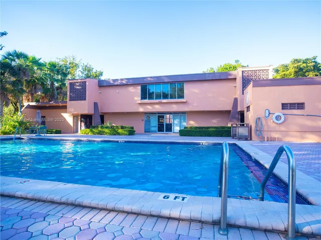 a view of swimming pool with sitting area and garden