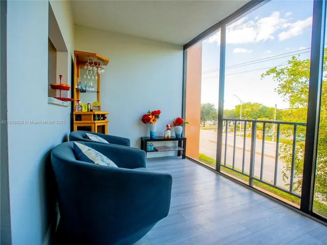 a living room with furniture and a floor to ceiling window