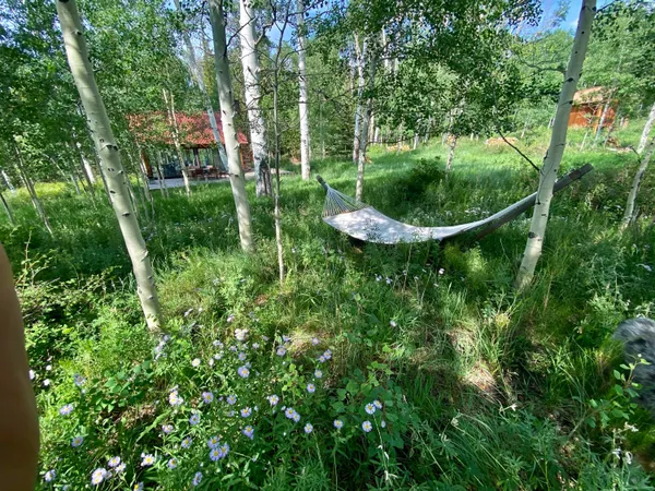 a backyard of a house with table and chairs