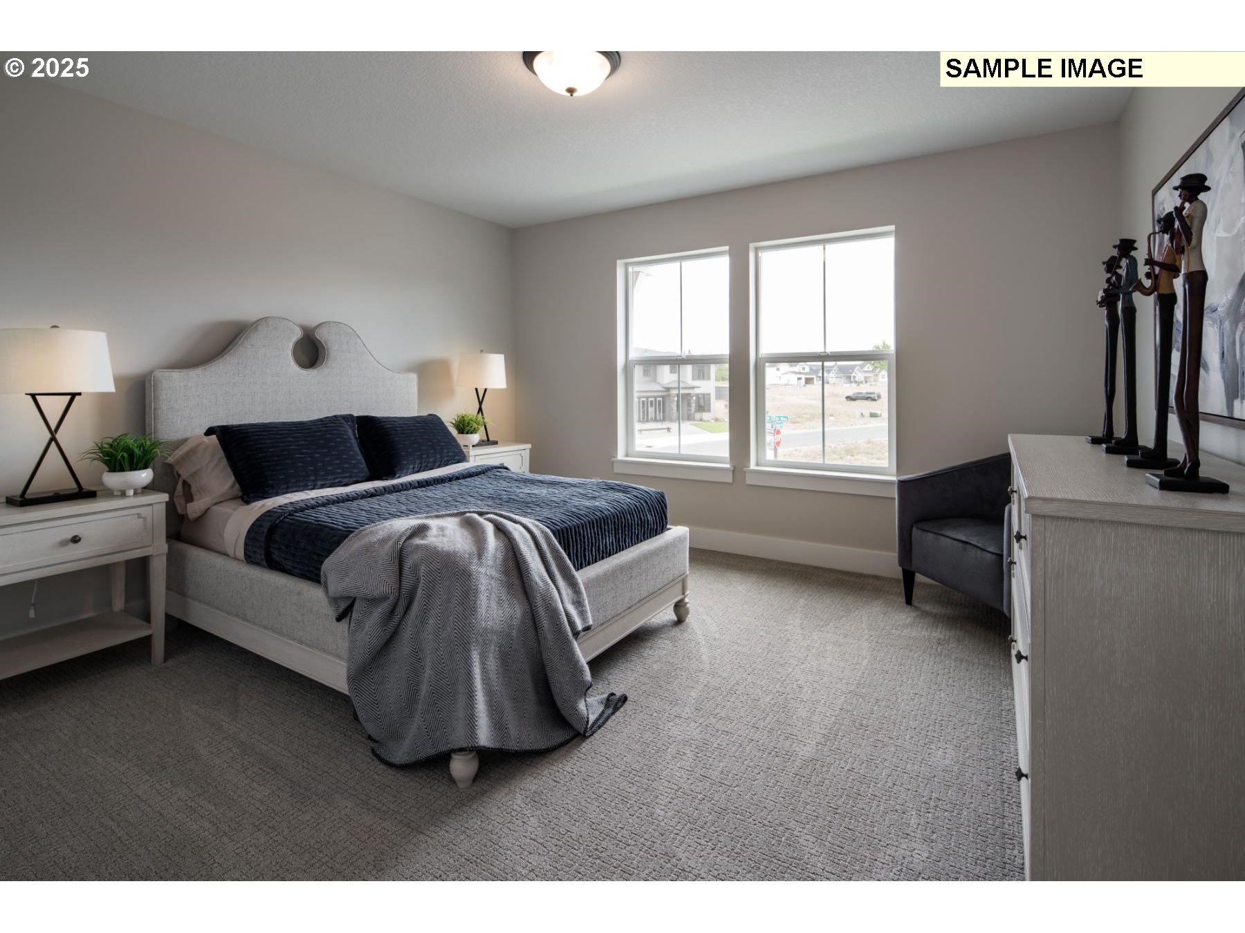8119 North Hargrave Street Camas, WA 98607 - Photo 20 of 23 a spacious bedroom with a bed a couch and a window
