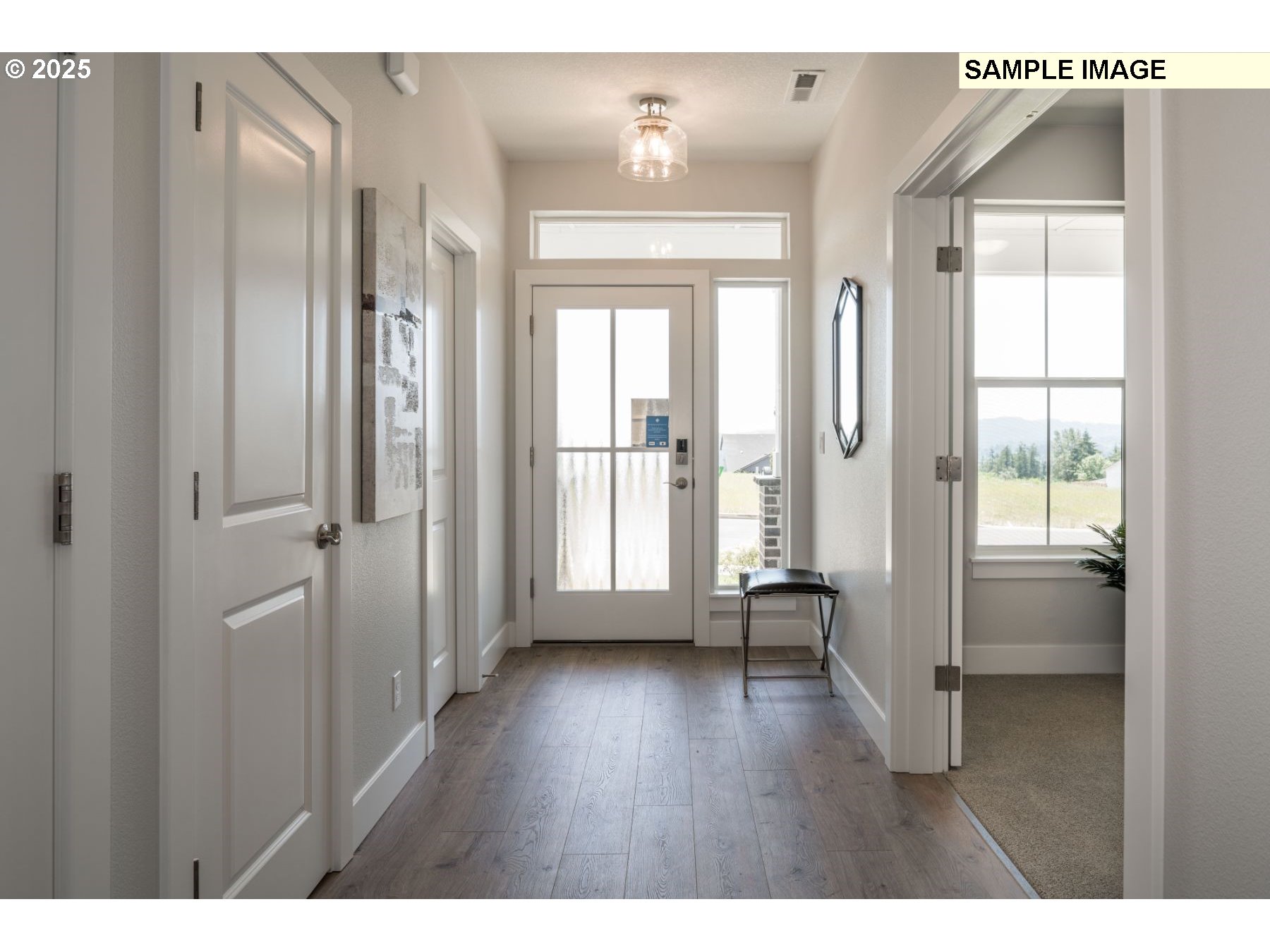 8119 North Hargrave Street Camas, WA 98607 - Photo 3 of 23 a view of a hallway with wooden floor and glass door