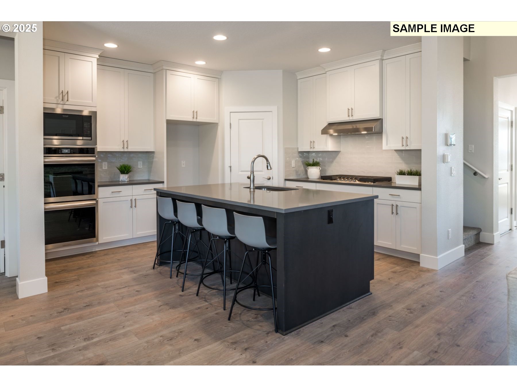 8119 North Hargrave Street Camas, WA 98607 - Photo 6 of 23 a kitchen with stainless steel appliances granite countertop a table chairs sink refrigerator and microwave