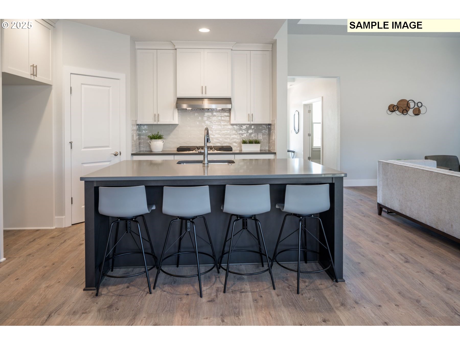 8119 North Hargrave Street Camas, WA 98607 - Photo 7 of 23 a kitchen with a dining table chairs and white cabinets