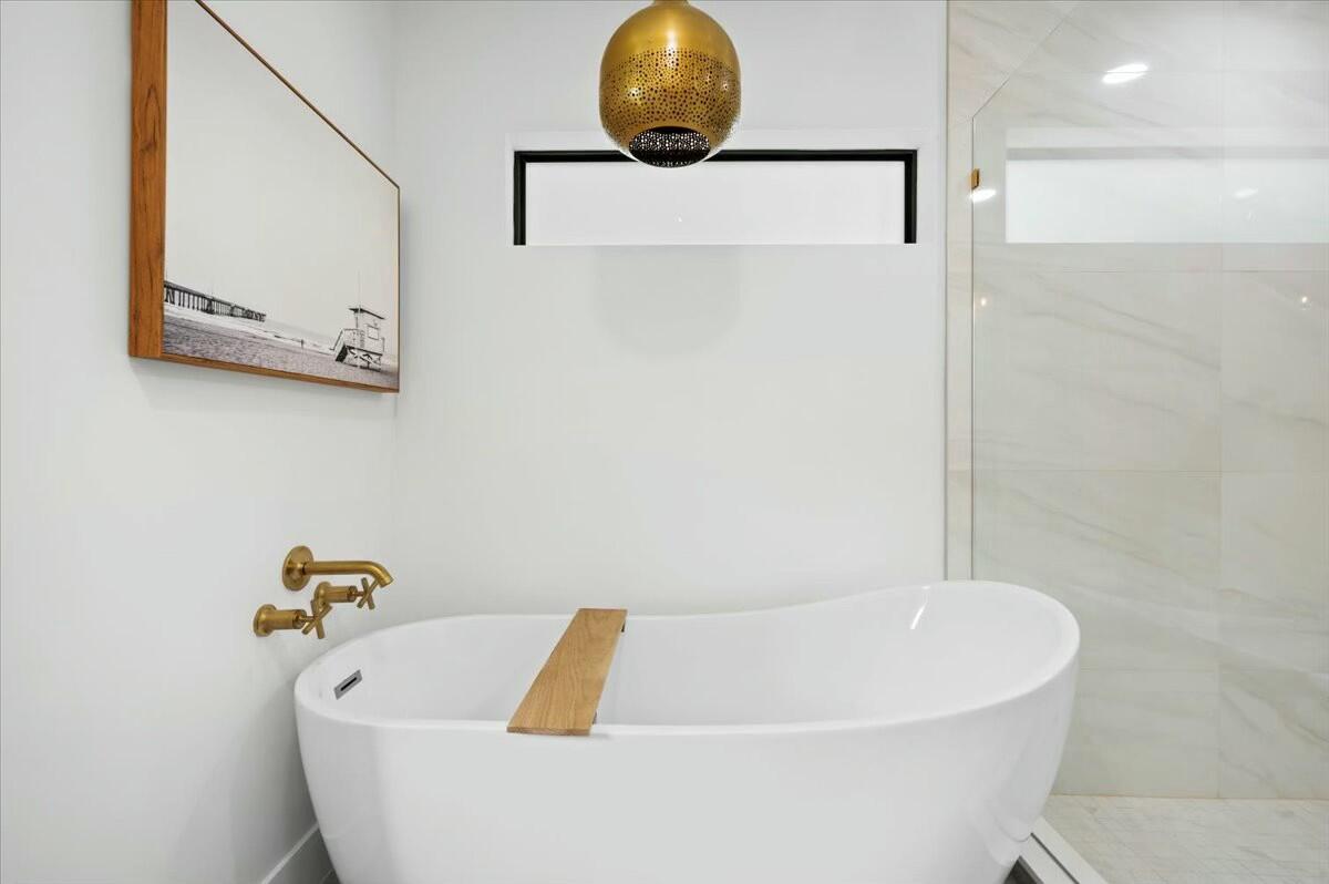 27 Ocean Drive Jupiter, FL 33469 - Photo 12 of 22 a bathroom with a tub and a shower