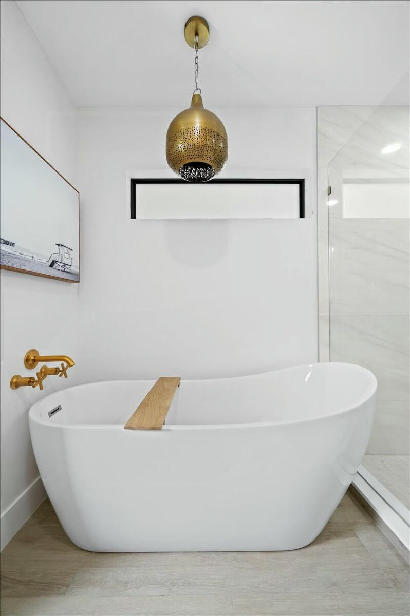 27 Ocean Drive Jupiter, FL 33469 - Photo 13 of 22 a white tub sitting next to a shower