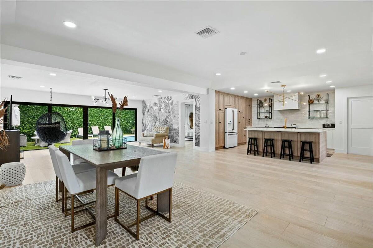 27 Ocean Drive Jupiter, FL 33469 - Photo 7 of 22 a living room with stainless steel appliances kitchen island granite countertop furniture and a large window