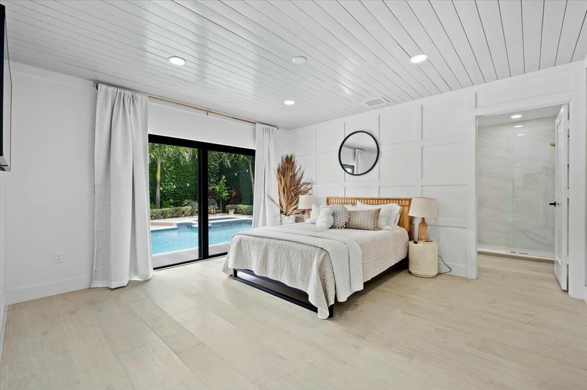 27 Ocean Drive Jupiter, FL 33469 - Photo 10 of 22 a spacious bedroom with a large bed and a large window