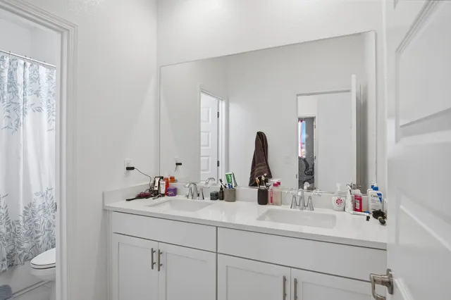 a bathroom with a sink and a mirror with toilet