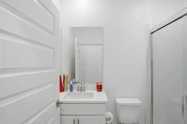 a bathroom with a sink toilet vanity and tub