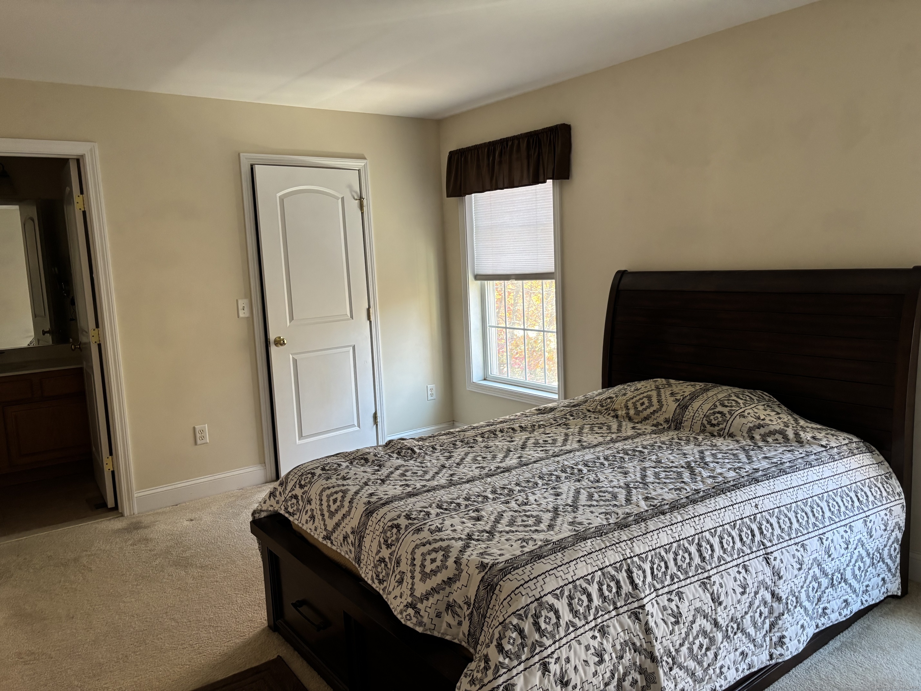 15 Freedom Way, Unit 22 East Lyme, CT 06357 - Photo 12 of 26 a bedroom with a bed and a window