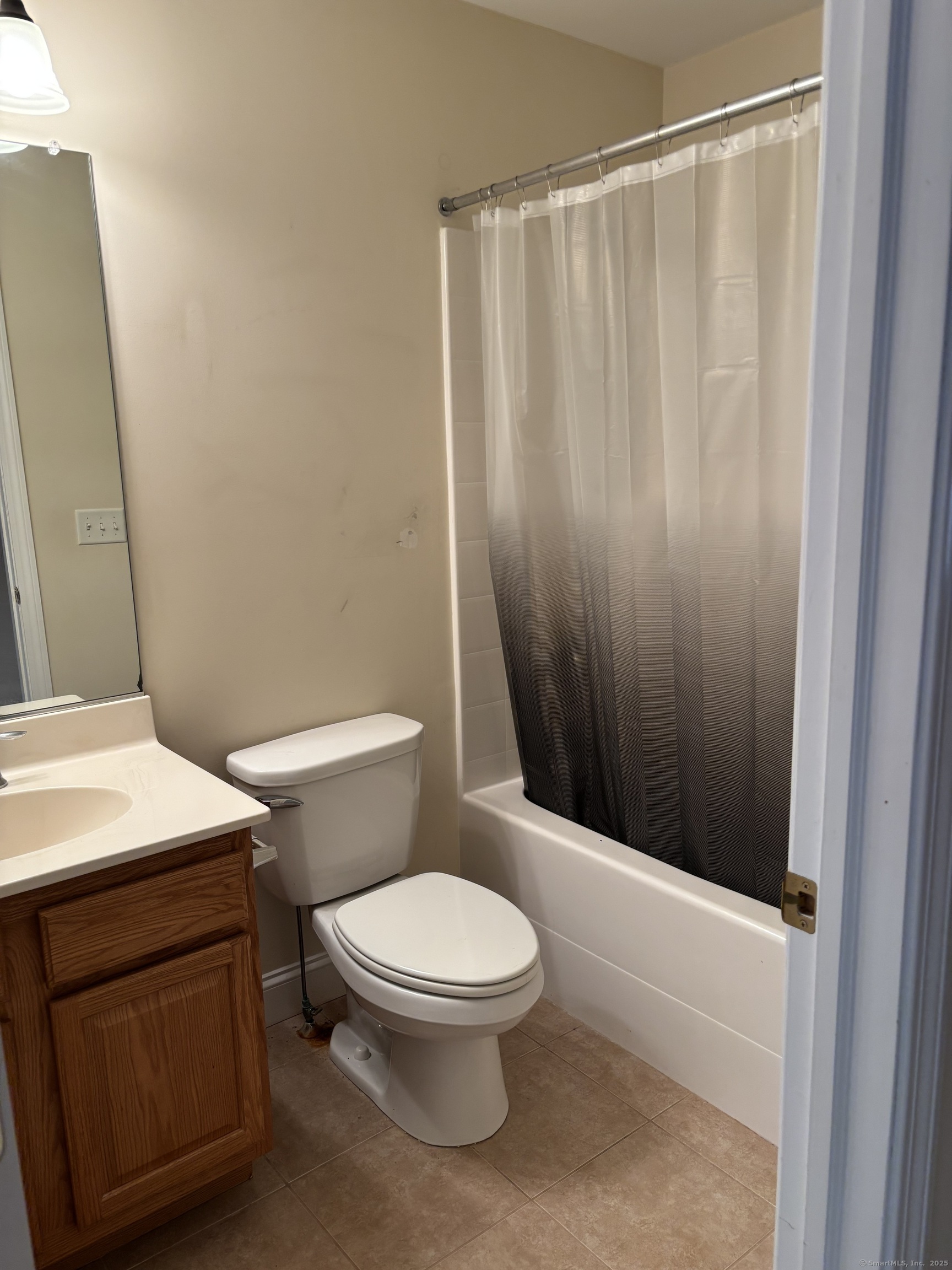 15 Freedom Way, Unit 22 East Lyme, CT 06357 - Photo 17 of 26 a white toilet sitting next to a bathroom sink