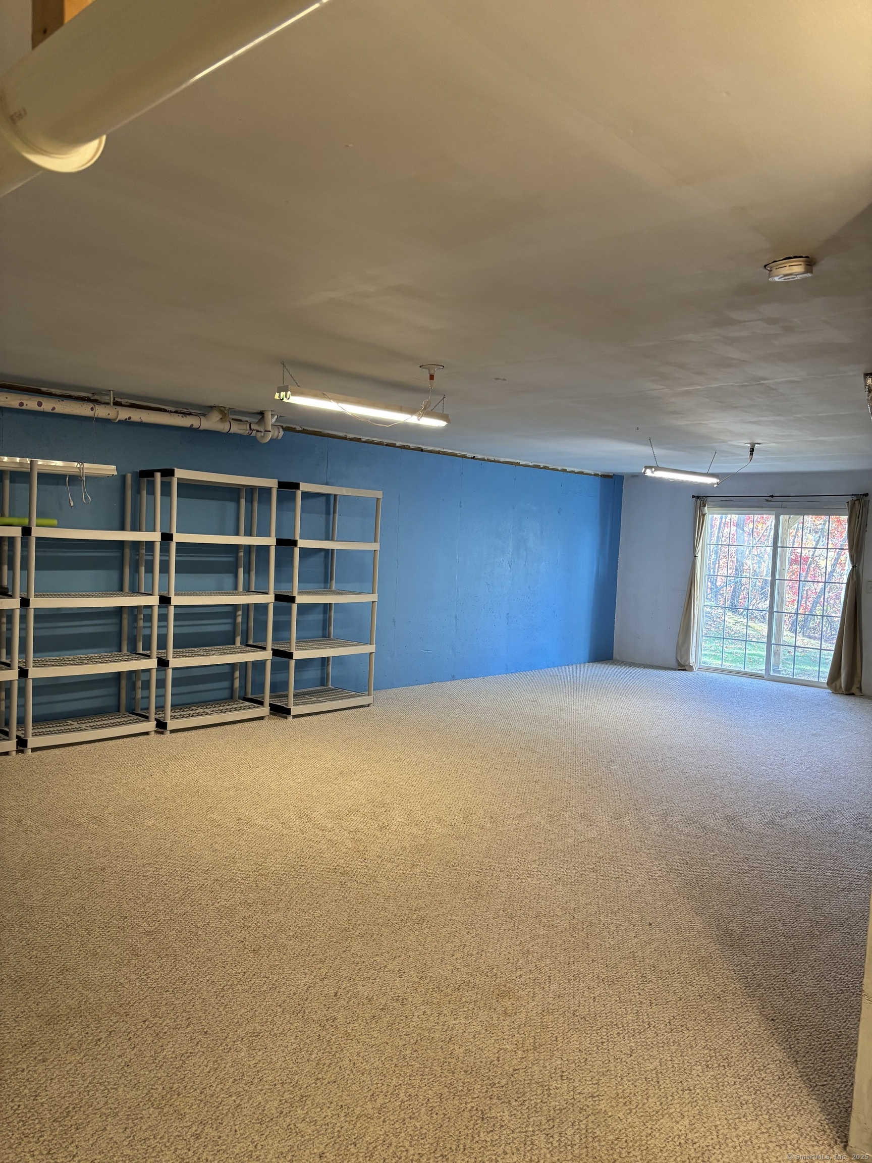 15 Freedom Way, Unit 22 East Lyme, CT 06357 - Photo 26 of 26 a view of an empty room with a window and cabinet