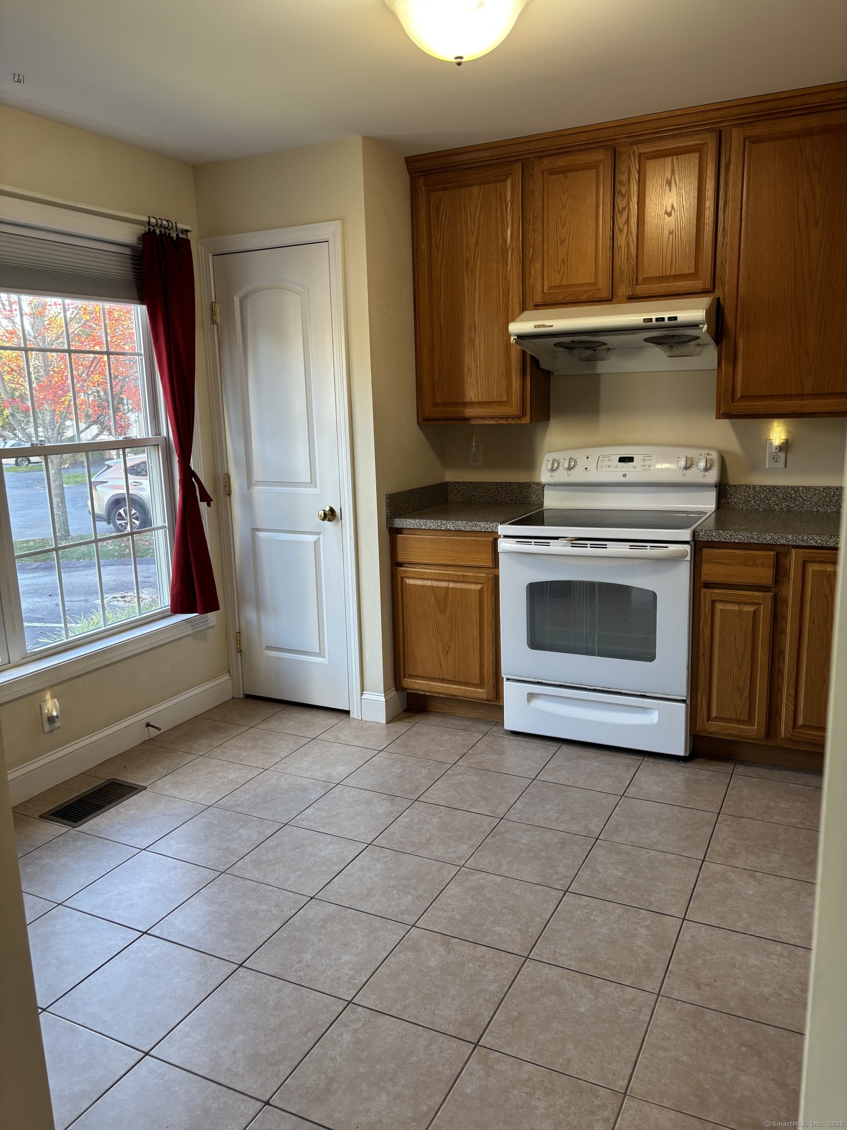 15 Freedom Way, Unit 22 East Lyme, CT 06357 - Photo 4 of 26 a kitchen with a stove top oven and cabinets