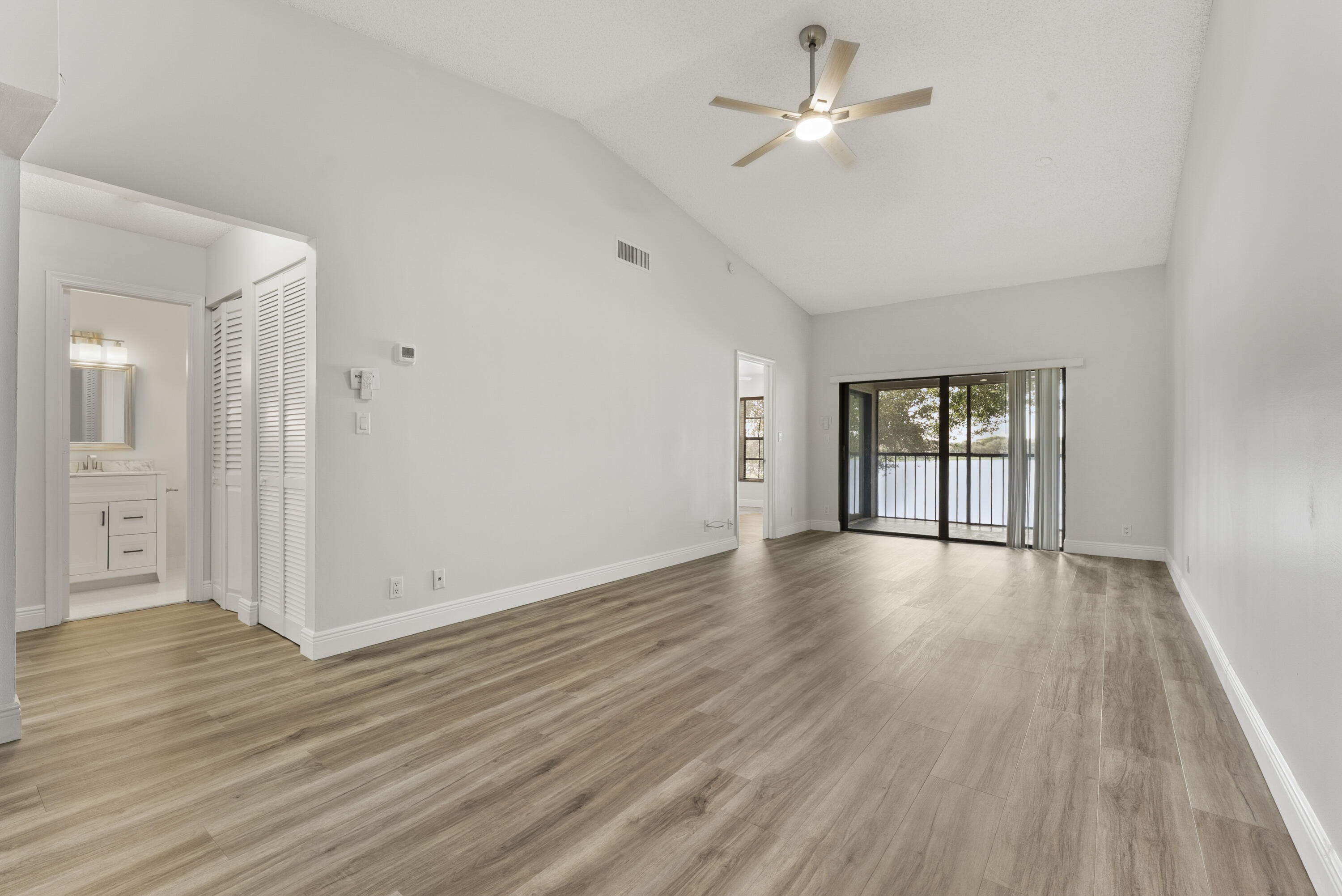 2900 Olivewood Terrace, Unit 2010 Boca Raton, FL 33431 - Photo 6 of 22 a view of an empty room with window and wooden floor