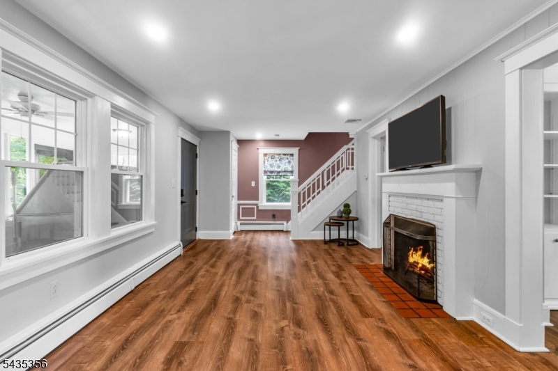 105 Somerville Road Bedminster, NJ 07921 - Photo 5 of 36 a view of an empty room with wooden floor fireplace and a window