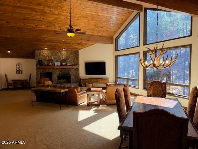 a living room with furniture a flat screen tv and kitchen view