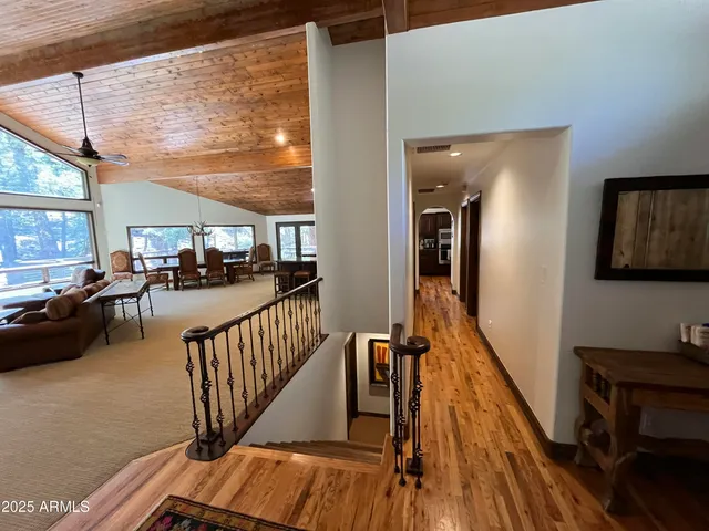 a view of a couches with wooden floor and furniture