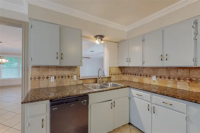 a kitchen with sink and cabinets
