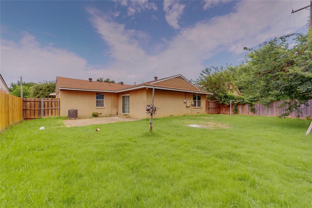 1610 North O'Connor Road Irving, TX 75061 - Photo 19 of 20 a front view of a house with a yard and trees