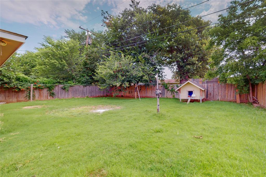 1610 North O'Connor Road Irving, TX 75061 - Photo 20 of 20 a view of a house with a backyard and a tree
