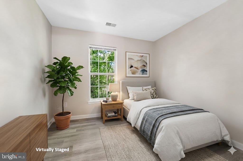 1461 Pangbourne Way Hanover, MD 21076 - Photo 31 of 51 a bedroom with a bed and a potted plant