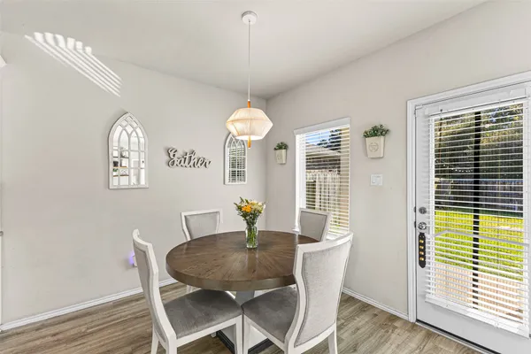 a view of a dining room with furniture window and wooden floor