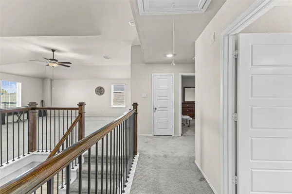 a view of a hallway with closet and stairs