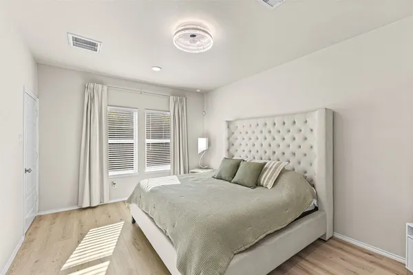 a bedroom with a large bed and a window