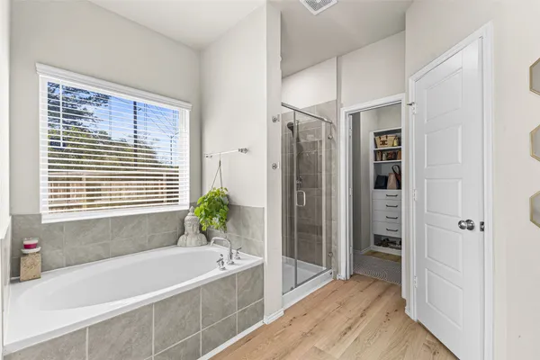 a bathroom with a bathtub and shower