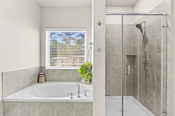 a bathroom with a bathtub and shower