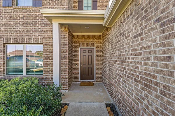 a view of a brick house with windows