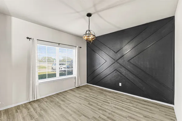 a view of a livingroom with wooden floor and a ceiling fan