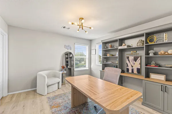 a room with furniture and view of kitchen